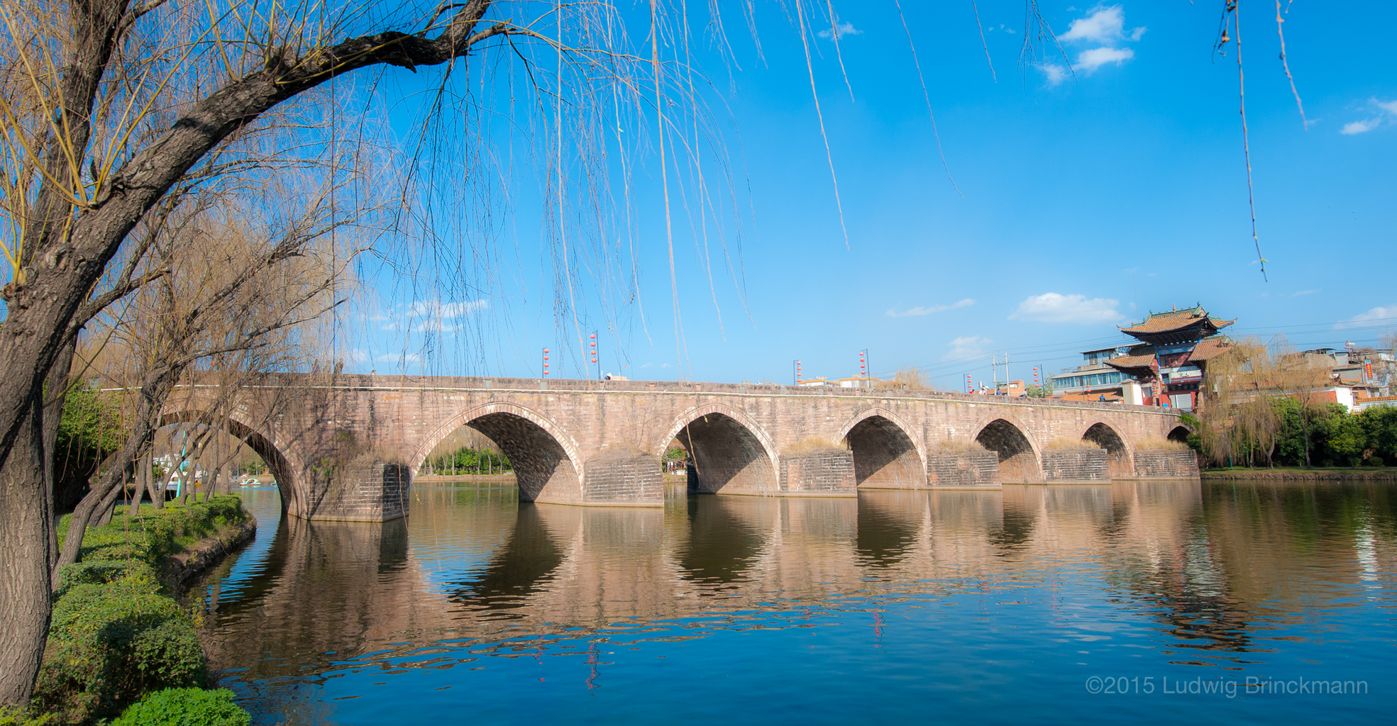 Picture: The main crossing of the Luyi River 禄衣河, one of the lowest points on the Kunming-Dali road, gave rise to what is today Lufeng Town. The Xingsu Bridge 星宿桥, build during the late Qing, still stands today, void of traffic in a park in Lufeng.