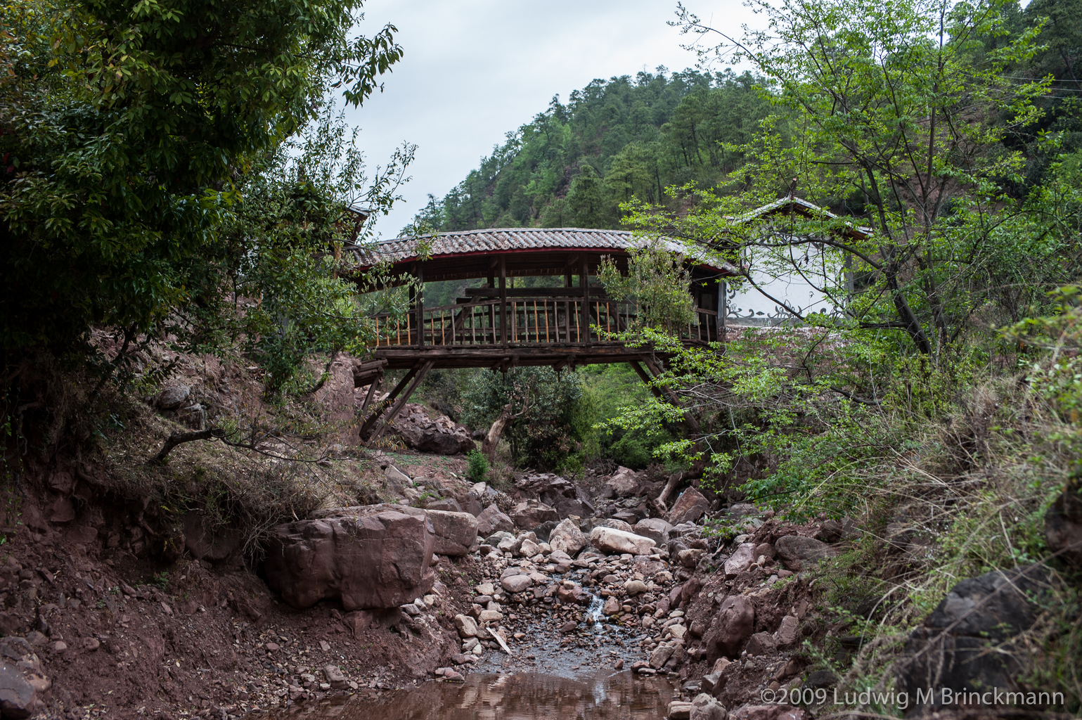 Picture: A covered bridge over a tributary to the Bijiang River.