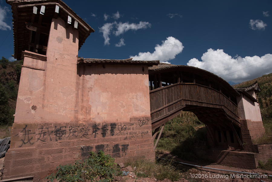 Picture: Covered bridge over a tributary to the Bijiang River.