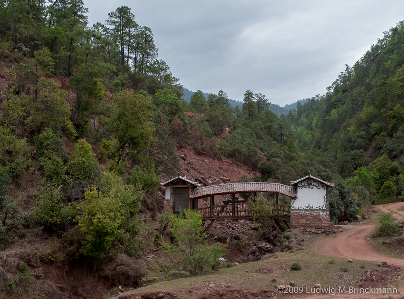 Picture: A covered bridge over a tributary to the Bijiang River.